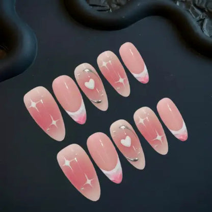 Set of pink and white nail designs with heart and star patterns on a dark background
