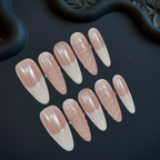 Set of pink and white nail tips on a dark surface