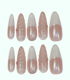 Set of pink and white nail extensions on a white background