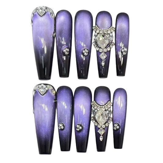 Set of purple nail extensions with decorative elements on a white background
