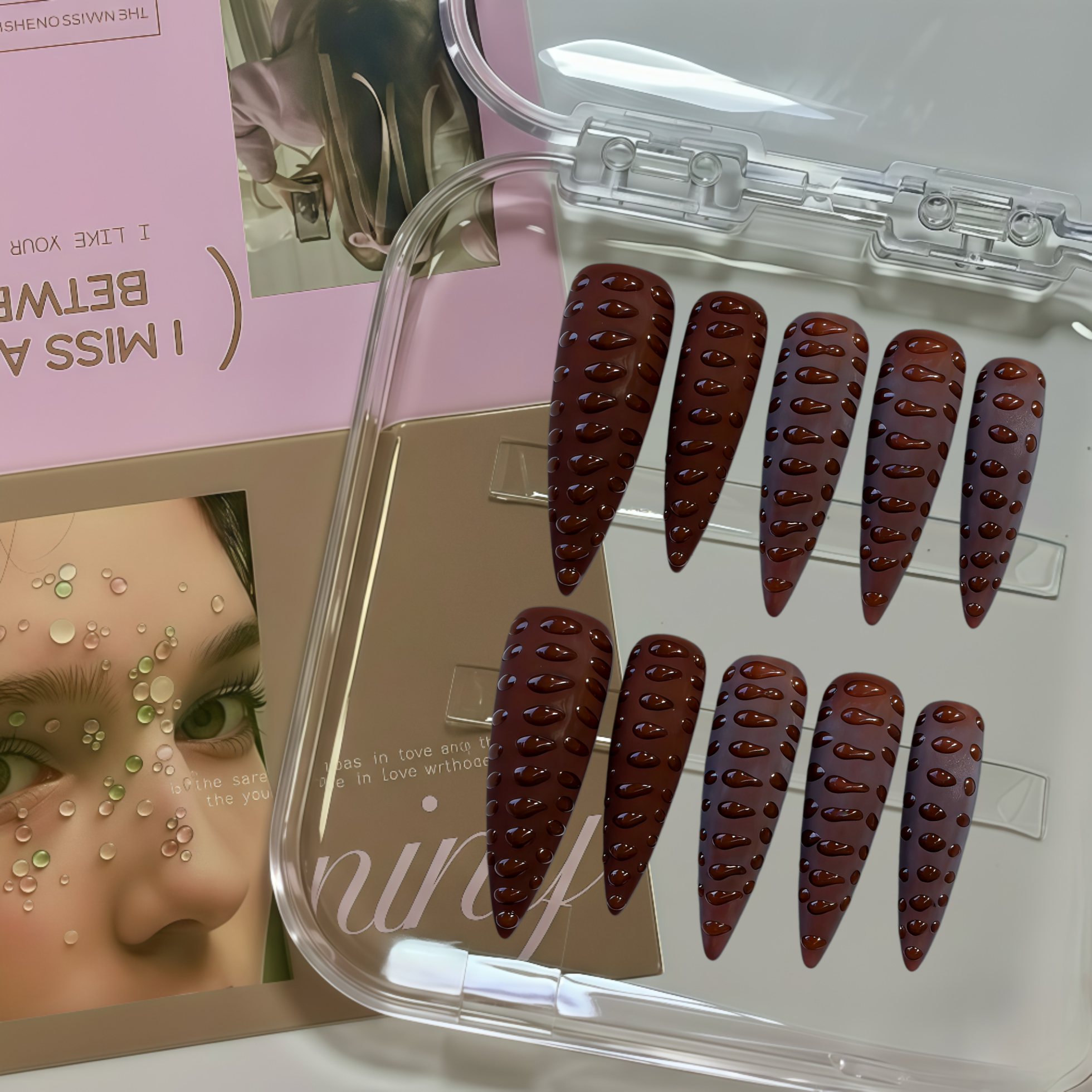 Set of false nails in a clear case with a magazine in the background