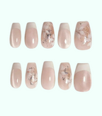 Set of pink and beige nail designs with floral patterns on a white background