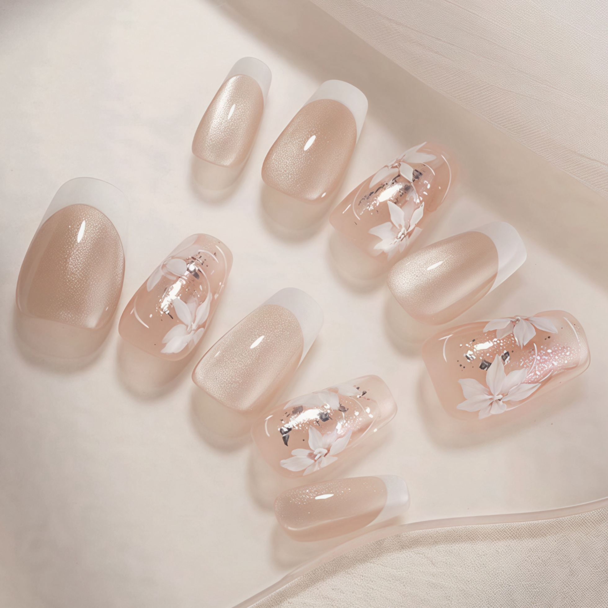 Nail art with floral designs on a neutral background