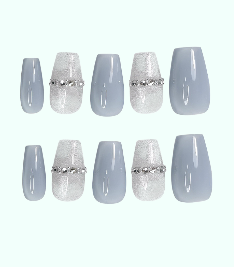Set of light blue press-on nails with silver decorative bands on a white background