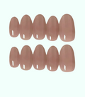 Set of nude-colored false nails on a white background