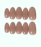 Set of nude-colored false nails on a white background