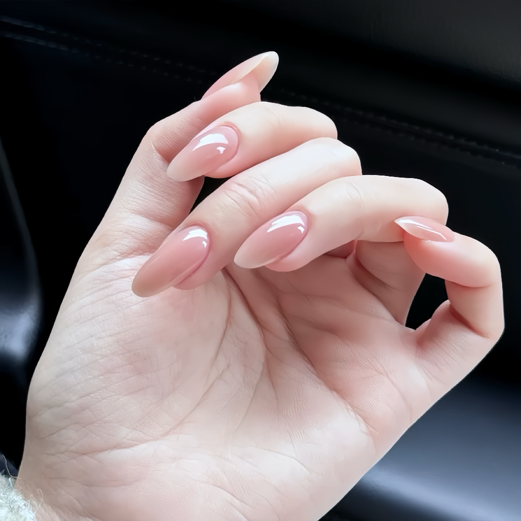 Close-up of a hand with pink nail polish on a dark background