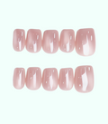 Set of pink false nails on a white background
