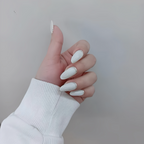 Hand with white nail polish giving a thumbs-up gesture against a plain background