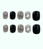 Set of black, gray, and silver nail art designs on a white background