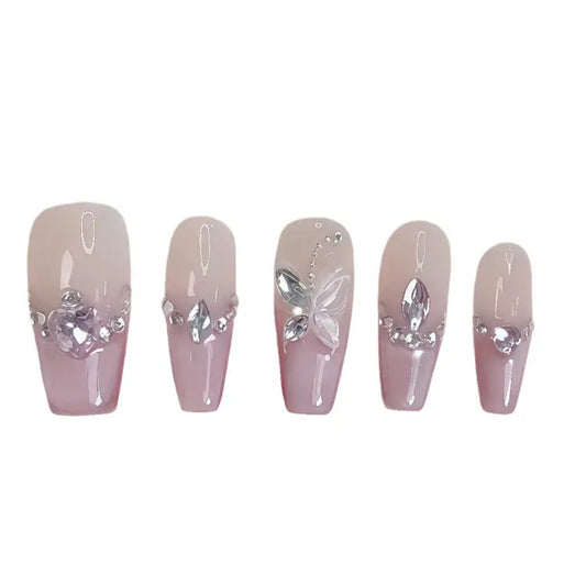 Set of five decorative false nails with silver butterfly and gem embellishments on a white background