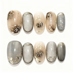 Nail art with floral designs on beige and silver nails