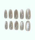 Set of beige nail polish strips on a white background