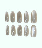 Set of beige nail polish strips on a white background