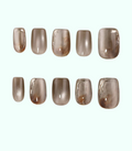 Row of brown nail polish samples on a white background