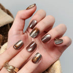 Hand with metallic nail polish on a neutral background