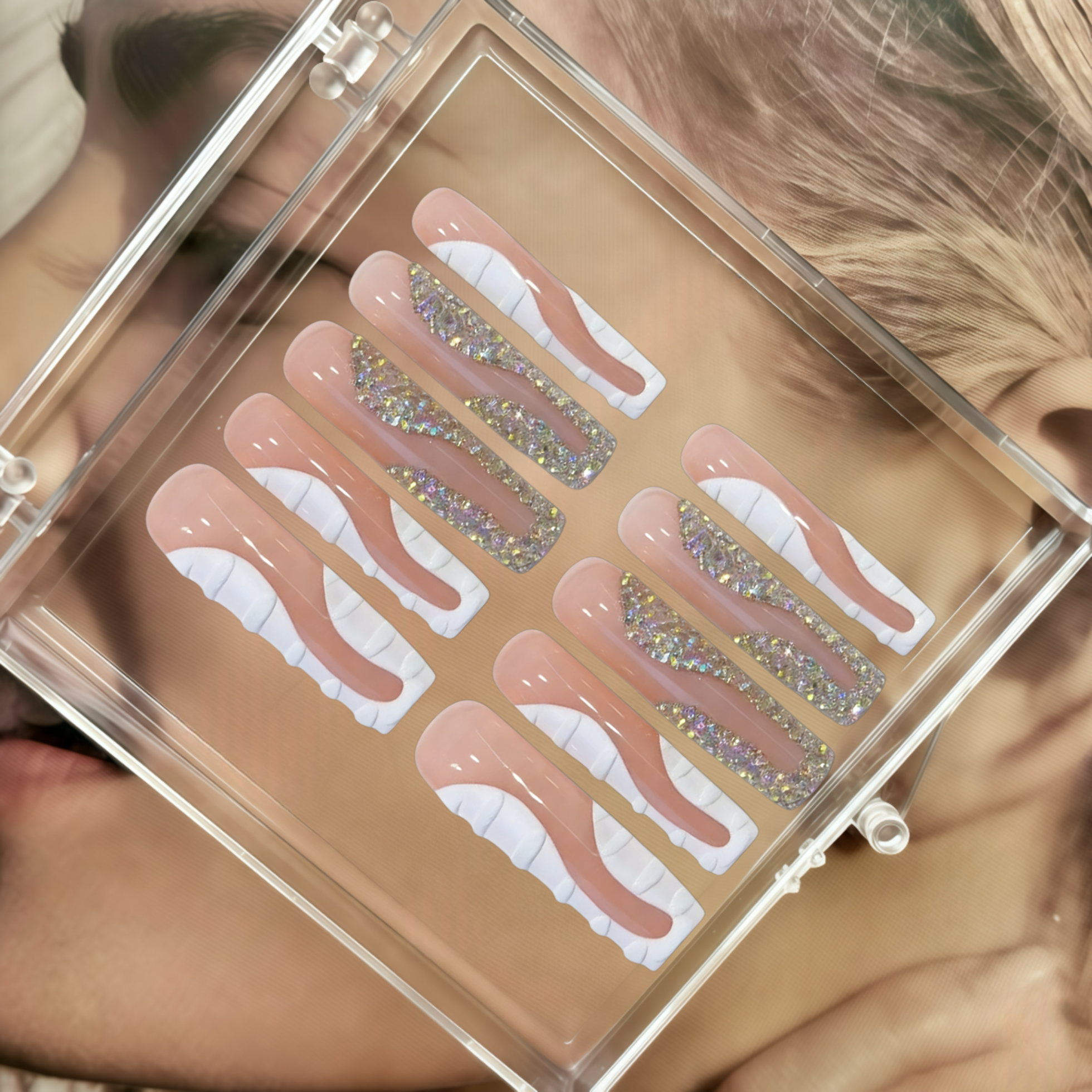 Set of false nails with glittery tips in a clear case.