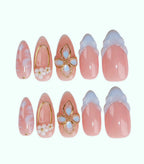 Set of decorative nails with floral and gold designs on a white background