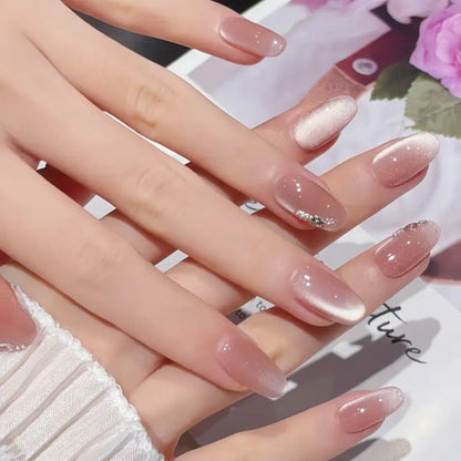 Close-up of hands with pink and white gradient nail polish on a blurred floral background