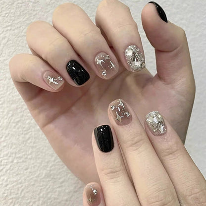 Hand with black and silver nail art on a white background