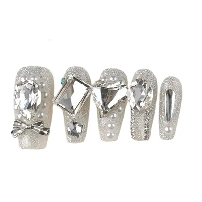 Decorative nail wraps with crystals and bows on a white background