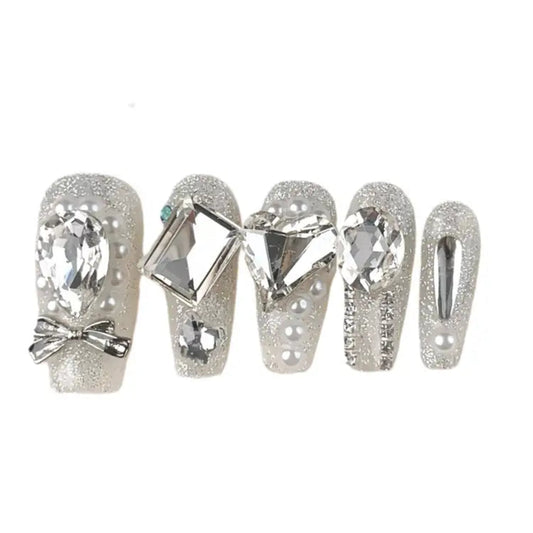 Decorative nail wraps with crystals and bows on a white background