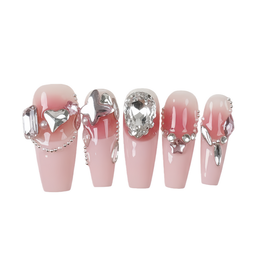 Set of pink nail extensions with decorative elements on a white background