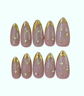 Set of pink and gold nail art designs on a white background