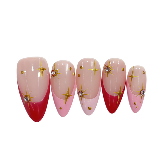 Set of five nail designs with red and pink gradient and gold star decorations on a white background