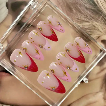 Set of pink and red nail designs with star decorations in a clear case.