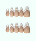 Set of beige nail stickers with decorative white tops on a white background