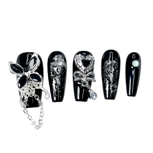 Set of black and silver nail art designs on a white background