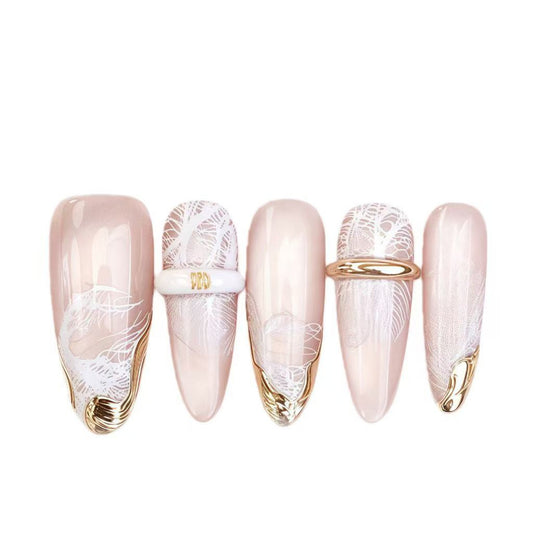 Set of decorative nails with floral designs and gold accents on a white background